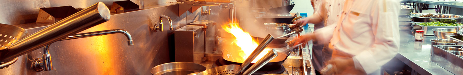 close-up of wok cooking in a professional kitchen