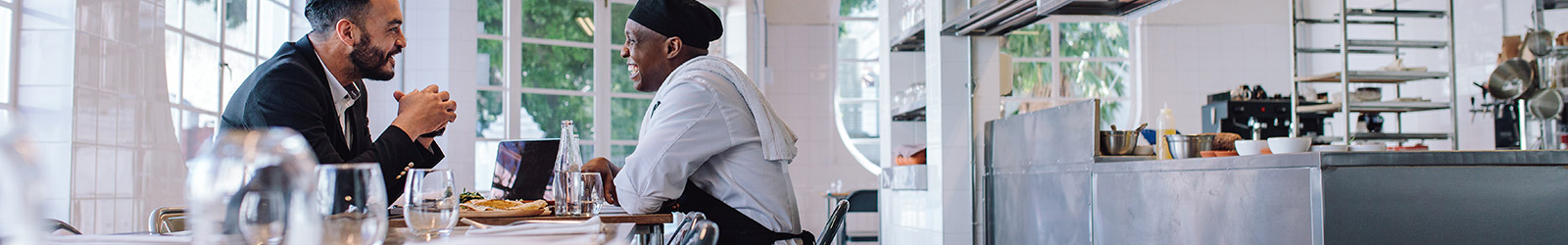 A chef sitting down for a chat with a customer